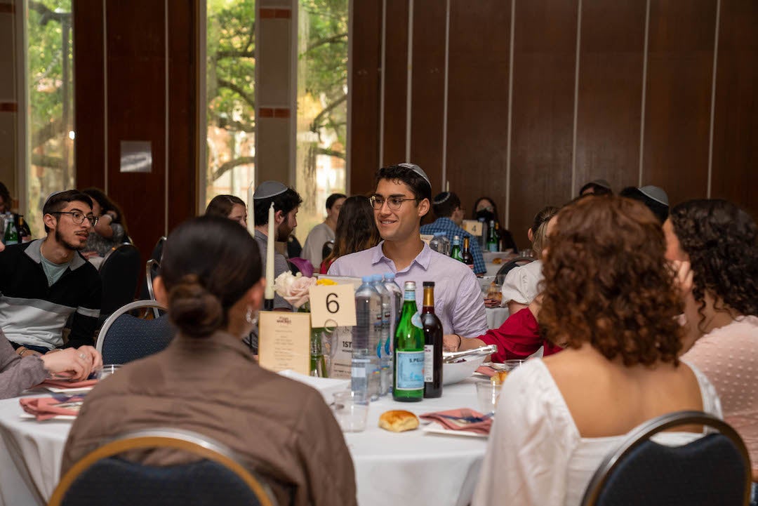 Rice students seated at table at Mega Shabbat 2023
