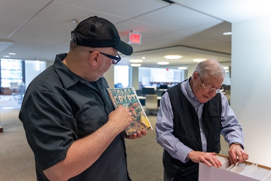 Christopher Sperandio, associate professor of visual and dramatic arts, and Rice alumnus Dr. Gordon Green ‘62 look through the collection of comics at the Comic Art Teaching and Study (CATS) Workshop in the Woodson Research Center at Fondren Library.