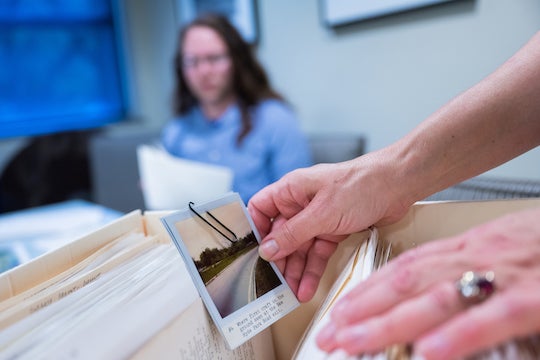 Rice undergraduate student Jonah Blunt looks through documents and photos from the Archives of Impossible.