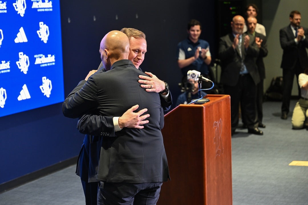 Rob Lanier is greeted by Tommy McClelland at his introductory press conference.