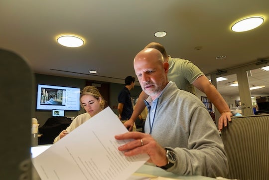 Lovett family members look through materials at the Woodson Research center.