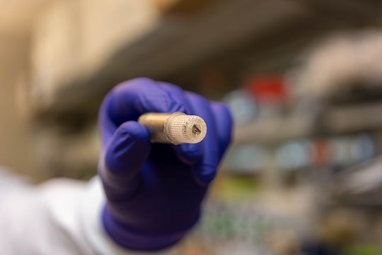 gloved hand holding a prototype