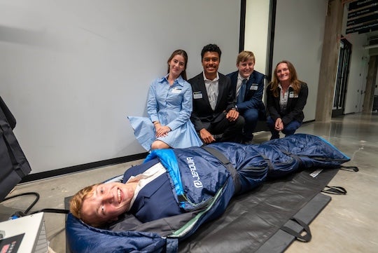 A team tests out a prototype of their device