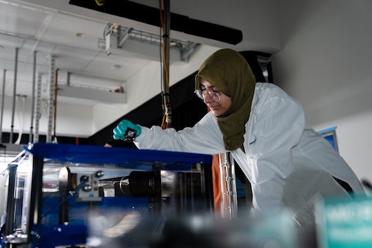 researcher interacting with equipment