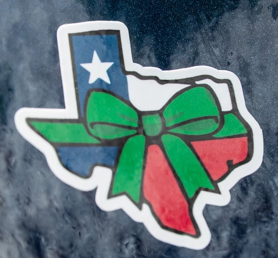 Green ribbon helmet stickers in honor of Texas flooding victims.