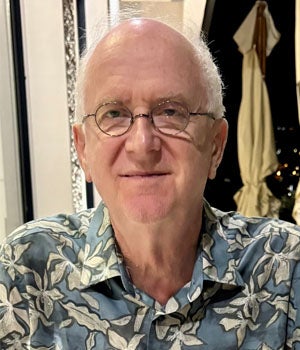 Portrait of Boris Yakobson with glasses and a patterned collared shirt.