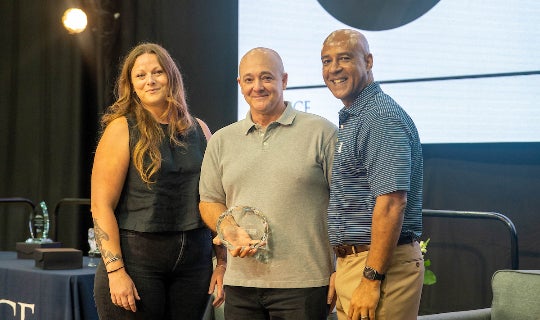 Brian Gibson (middle) poses with Jessica Keithan (left) and President Reginald DesRoches (right)