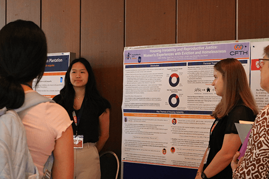 Caitlin Reddig and Tegan Tien presenting poster at Humanities and Arts Festival