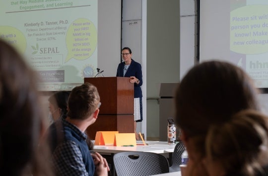 Professor Carissa Espinosa welcomes faculty, staff and students to the workshop.