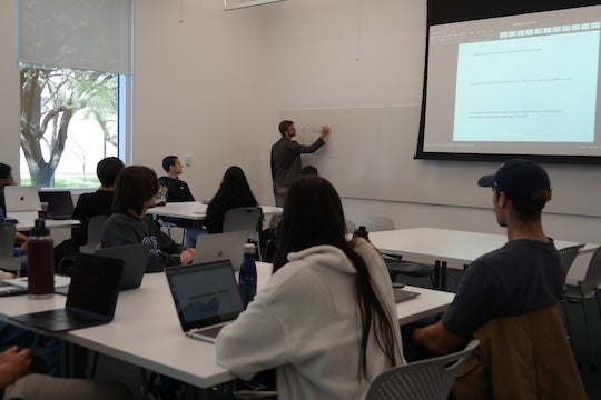Scott Powers teaches students in a data science class at Rice University.