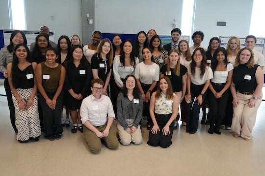 Rice students participating in the Community Bridges program gather following the end-of-year poster showcase highlighting their community-engaged research projects.