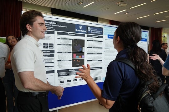 Cory Voskanian discusses his research on social vulnerability in Harris County during the Community Bridges poster showcase.