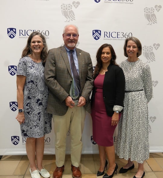 Dr. Gordon E. Schutze (second from left), receiving the Rice360 Global Champion Award with Rice360 co-directors Maria Oden (left) and Rebecca Richards-Kortum (far right) and executive director Yvette Mirabal (second from right). (Photo by Ebony Thornton)
