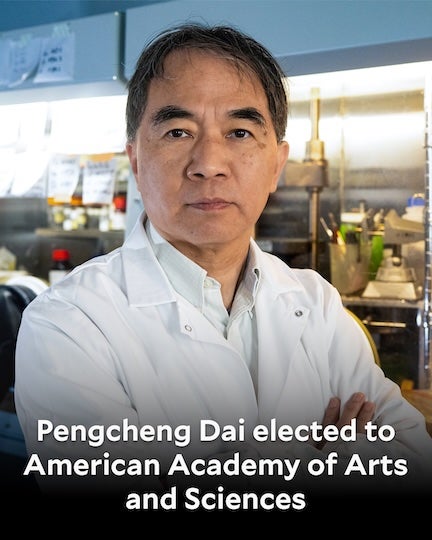 An Asian man in a lab coat stares confidently at the camera