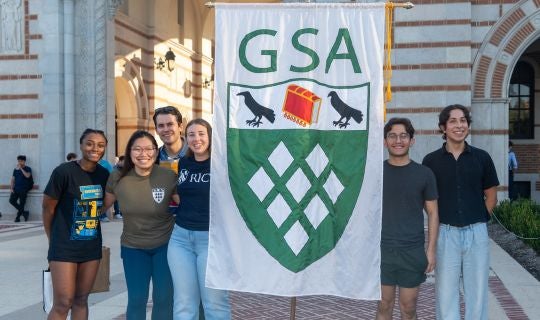 studnets holding a banner that says GSA in front of Lovett Hall