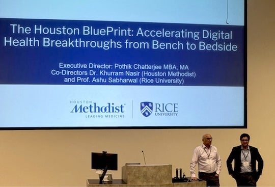 event photo of lead organizers beside a podium