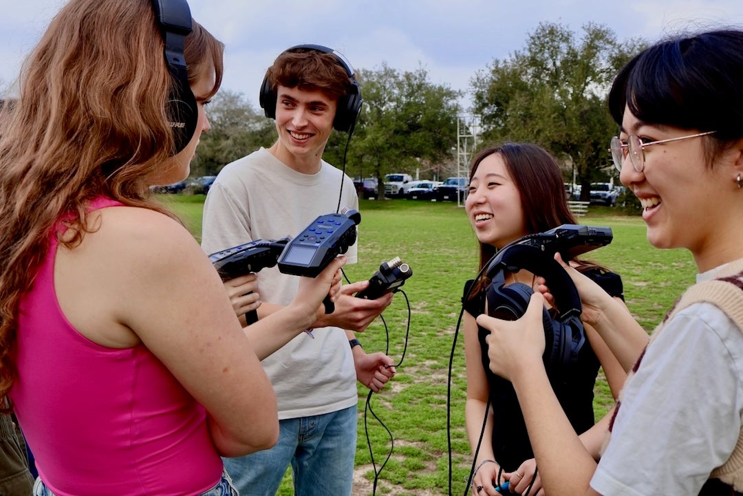 Students from the Houston Newsroom test out their new equipment.