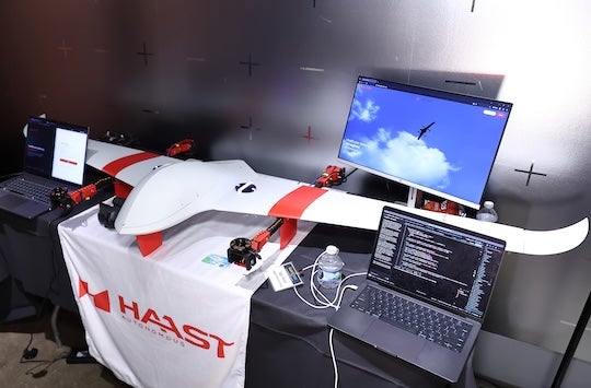 drone prototype on a display table next to laptop