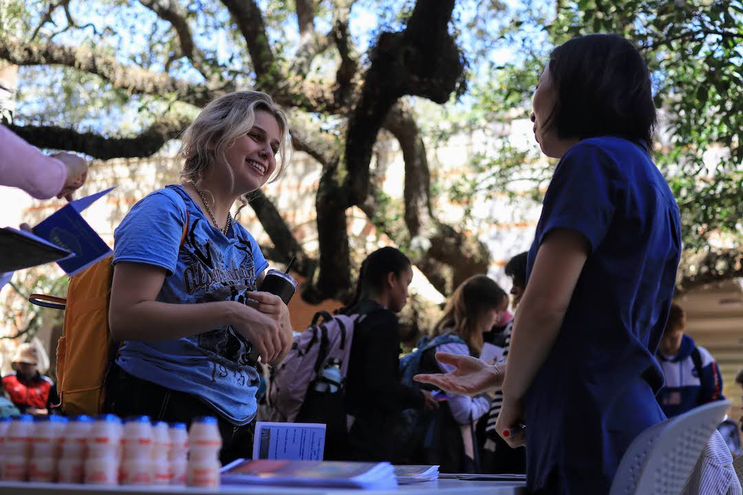 Student speaking with professor during Humanities event