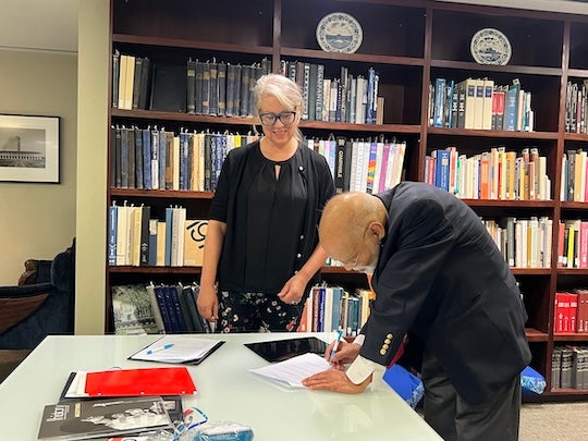 Amanda Focke (left) and foundation president Krishna Vavilala (right) sign the MOU.