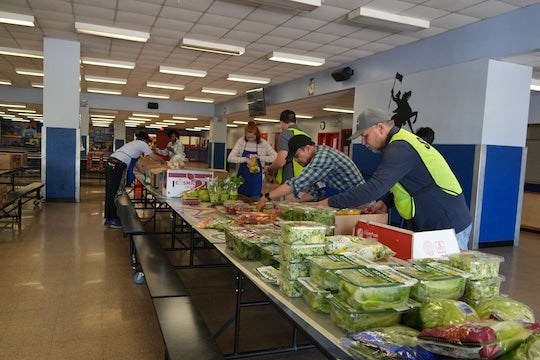 Volunteers organize rescued food at Paul Revere Middle School during a Second Servings pop-up, where Rice students joined the team to observe operations as part of their Social Policy Analysis capstone project.
