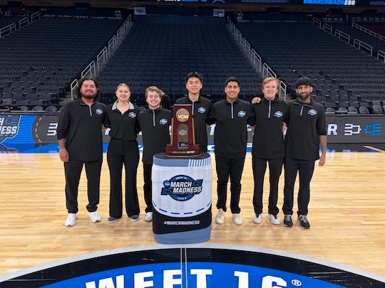 Rice University sport management students pose with the South Regional trophy at Toyota Center, where they worked as court attendants during the Sweet 16 and Elite 8. Photo courtesy of Jacob Lozano