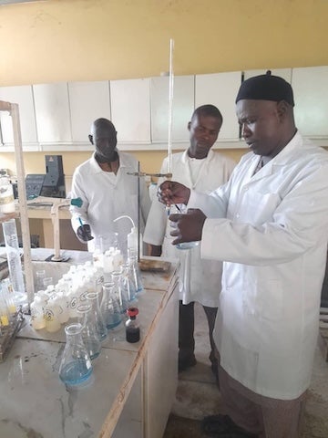 Members of Adam Lawan Ngala’s lab, Professor of Soil Science at the University of Maiduguri, analyze soil samples 