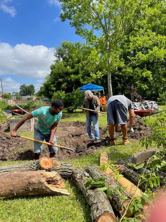 “Volunteers dig the Trinity Gardens Community Rain Garden in June 2022