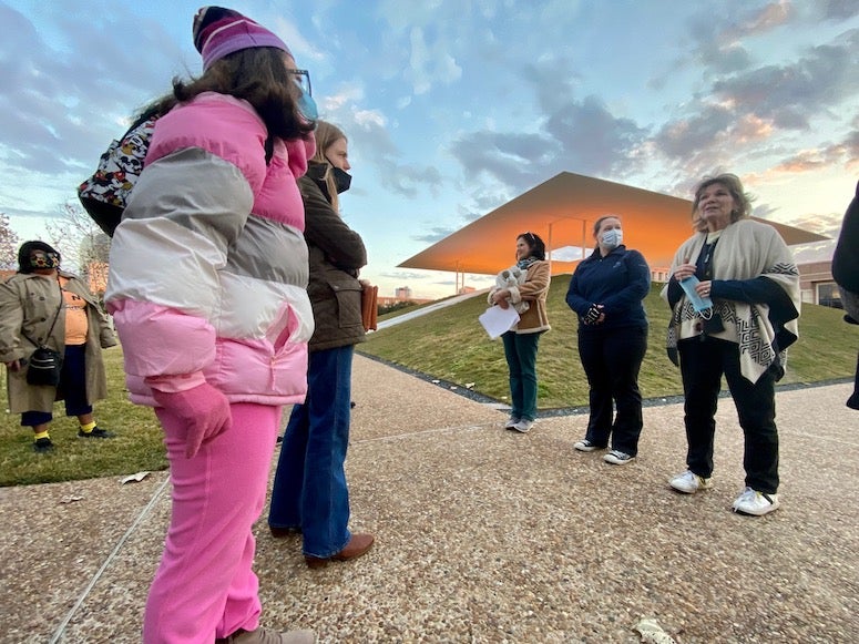 Maria Corcuera, Andy Meretoja and Adria Baker of the OISS in front of the James Turrell Skyspace at dusk