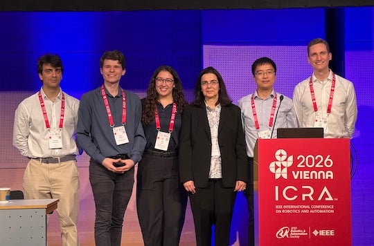 group of six people standing on a stage