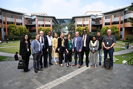 2024 delegation posing on the Infosys campus in Bengaluru