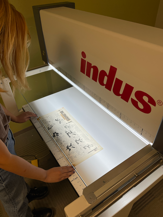 Fondren Fellow Irene Wang scanning comic art gifts