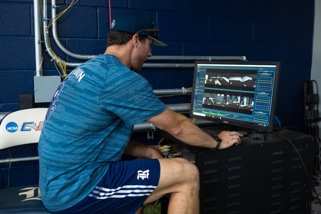 Rice Owls pitching coach Colter Bostick uses sport analytics software to analyze player performance. Photo by Jeff Fitlow.