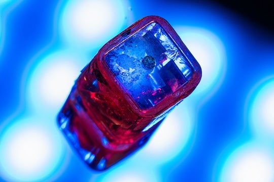 early device prototype shot with a macro lens over a reflective background 