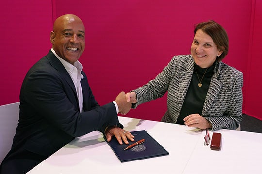 Reginald DesRoches shaking hands with Claudia Felser of the Max Planck Institutes