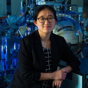 An Asian woman smiles at the camera