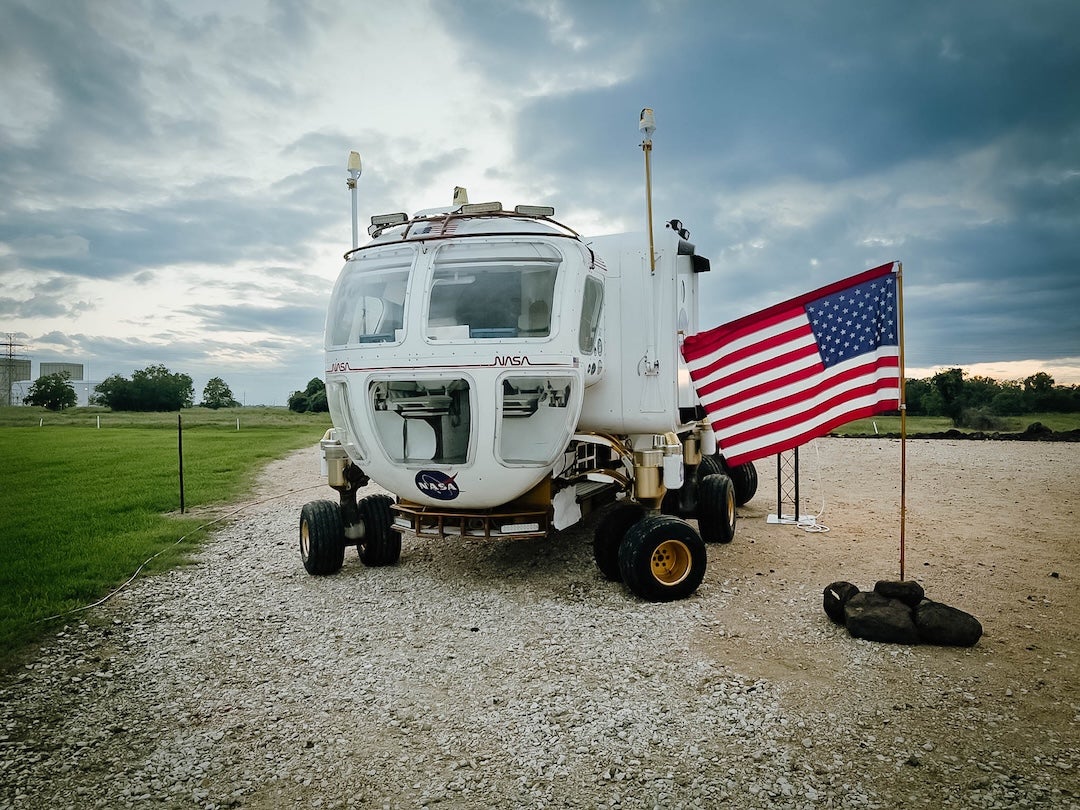 A picture of a pressurized rover at NASA’s Johnson Space Center. Team OWL SUITS was assigned to develop a pressurized rover interface for a simulated lunar mission scenario (Credit: Israel Cantu). 