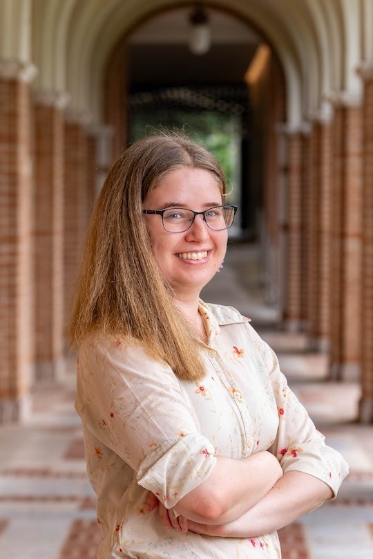 A white woman smiles at the camera