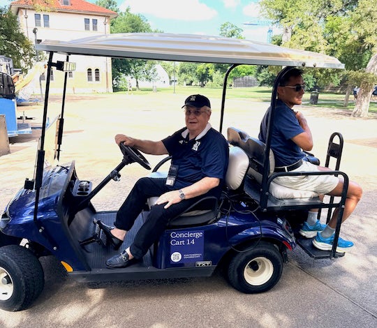 Leaders from across the university, including senior executive director of campus services and sustainability Eugen Radulescu (at left), were up early Sunday to support Move-In Day activities. 