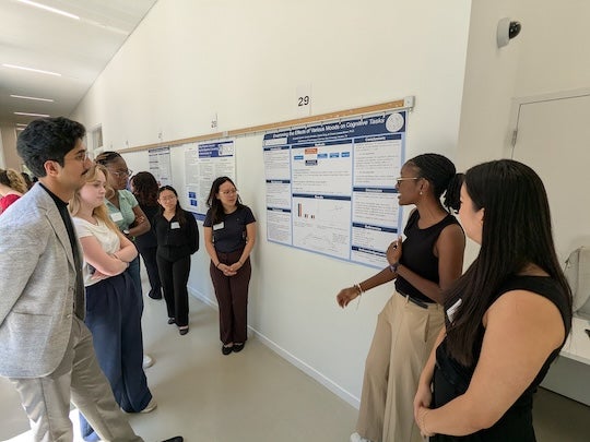 Rice undergraduate students present and discuss their research posters during the 2025 Social Sciences Undergraduate Research and Creative Symposium