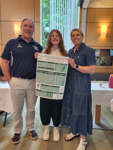 Ava Cheponis presents her research on adolescent participation in team sports during a poster presentation at the University of Limerick in Ireland. (Photo courtesy of Ava Cheponis)