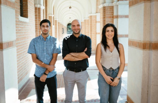 Farshid Alambeigi, center, with graduate students Daniyal Maroufi (left) and Mobina Tavangarifard (right). 