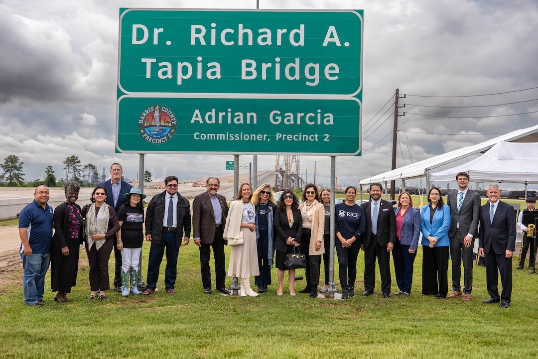 A group of people stand in front of a large sign that says: Dr. Richard A. Tapia Bridge