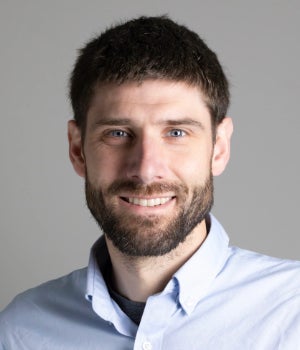 A middle-aged white man smiles at the camera