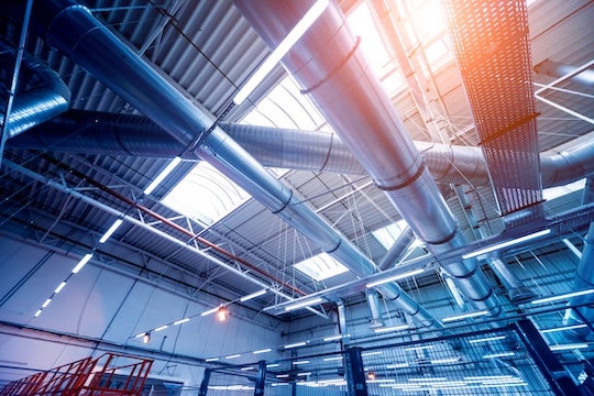 A stock image of an air conditioning system in an industrial building. 
