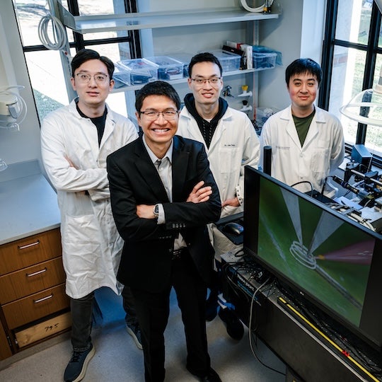 Yong Lin Kong and his team standing in his lab