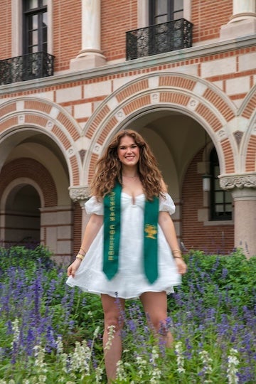 Schultz's graduation photo posing in flowers