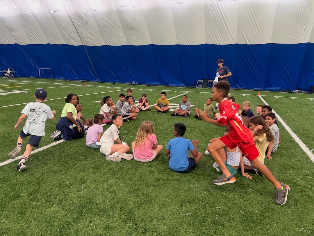 STEM-letics campers running around a field
