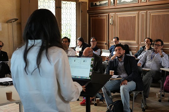 Audience of presentation at the Human Flourishing in the Age of AI conference including organizers Rodrigo Ferreira and Robert Howell