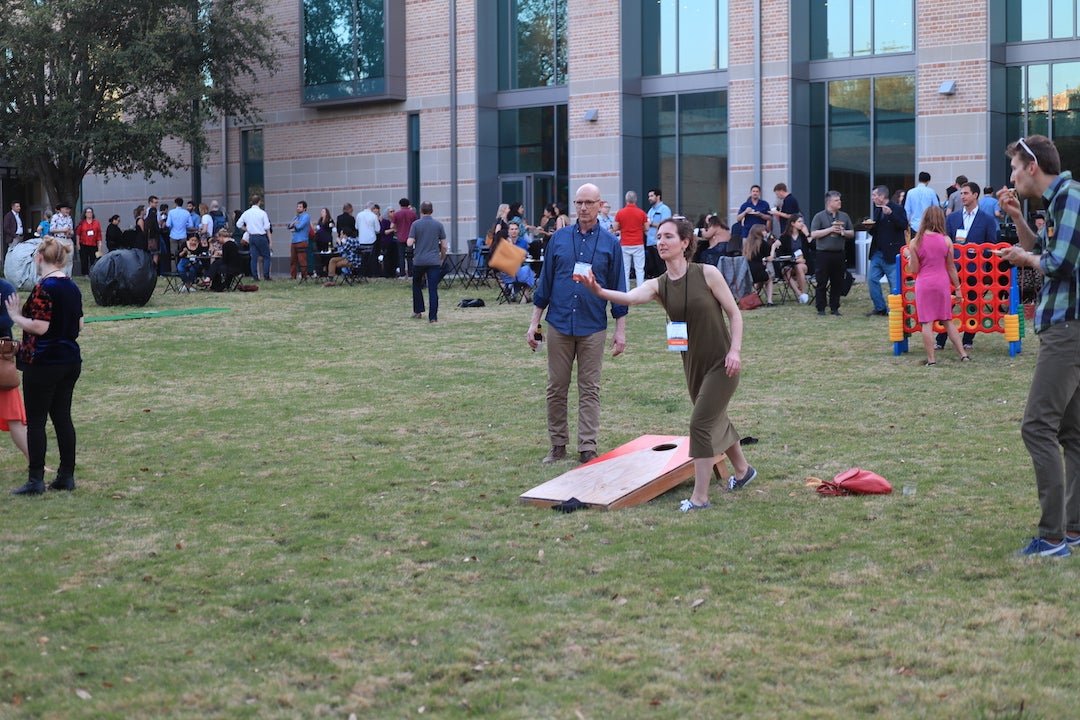 Conference attendees playing yard games at mixer event